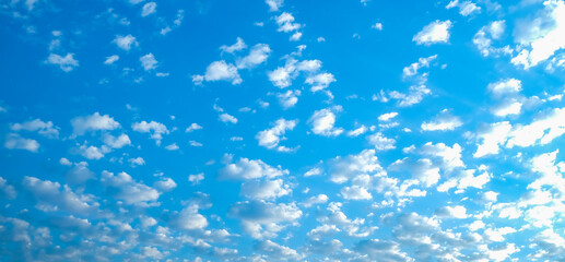 Fototapeta na wymiar Blue sky with white clouds. Beautiful cloudy sky. Skyward. Endless skyline. The sky at dawn. Banner.