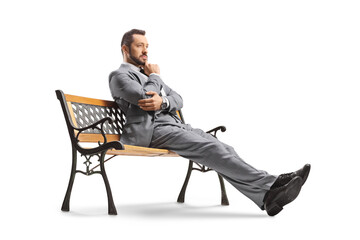 Pensive businessman sitting on a bench
