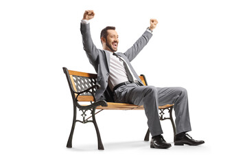 Businessman sitting on a bench and gesturing happiness