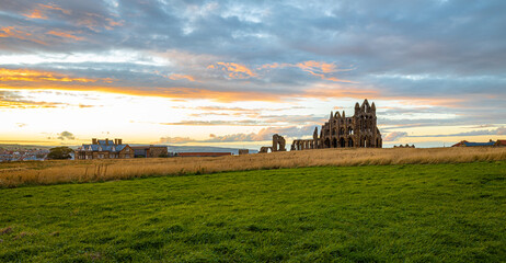 Sunset view of Whitby abbey overlooking the North Sea on the East Cliff above Whitby in North Yorkshire, England