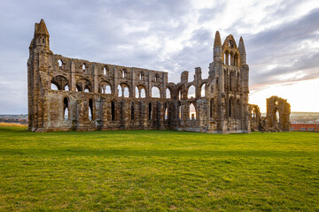 Fototapeta premium Sunset view of Whitby abbey overlooking the North Sea on the East Cliff above Whitby in North Yorkshire, England