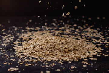 Falling oatmeal on wooden background