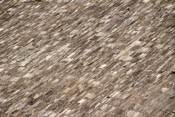 Full frame abstract texture background of a deteriorating century old barn roof comprised of cedar shake shingles