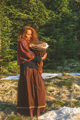 Fototapeta premium Beautiful shamanic girl playing on african drum drum in the nature.
