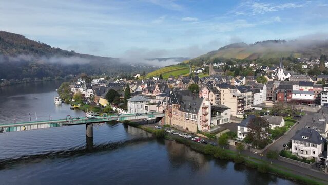 Aerial Drone Shot in autumn of Traben-Trarbach with Morning Fog. River Moselle in early fall, Germany. Moselland.