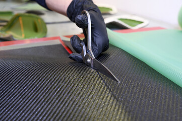 Preparation and cutting of a real carbon fiber sheet for the industrial production of a component...