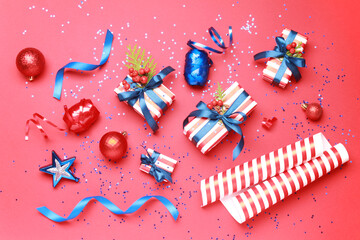 Wallpaper greeting card Merry Christmas holiday composition with blue white striped gift box present toy ball decoration on red background. Xmas New Year winter design idea concept. Top view, Flat lay