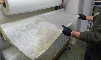 Installation of fiberglass sheets in various sizes ready for the creation of industrial composite...