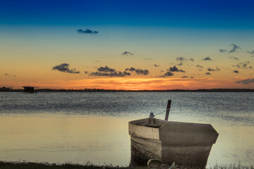 boat on the beach at sunset