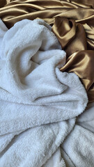 mix of textures white blanket and satin sheet fluffy tissue flowing woven weave suit evocative of a kiss