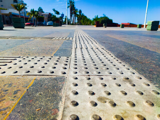 Braille block on a public sidewalk for people with disabilities, blind people