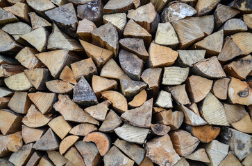 Pile of chopped firewood. Natural wooden texture or background