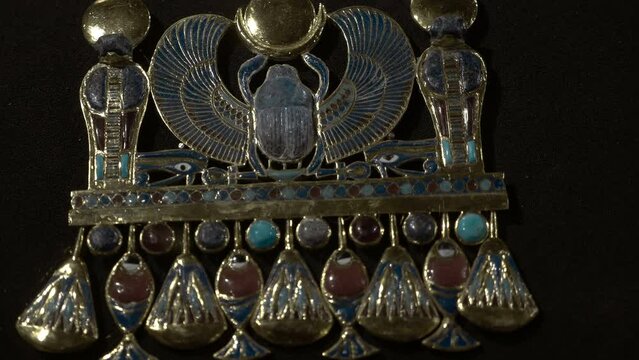 Golden ancient egyptian jewelry is one of the exhibits of the tomb of Tutankhamen, a symbol of Ancient Egypt. Shot in motion. Closeup
