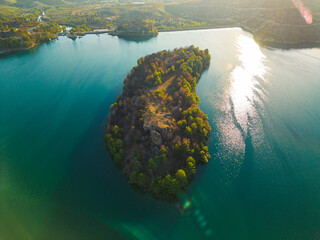 Green Mountain lake Manavgat in TUrkey. Top drone view of deep green water and a little islandwith...