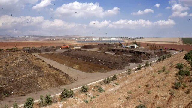 Aerial shot of an Industrial compost production site. Large rotary compost screening machine filtering compost