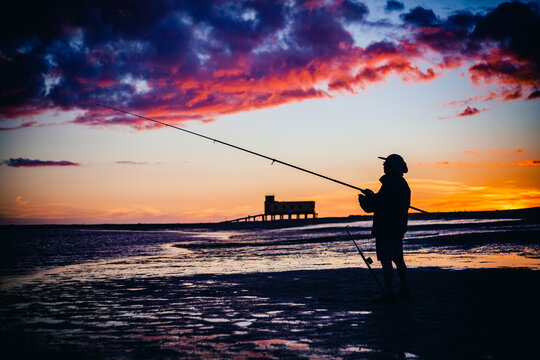 fishing on the fuseta beach in algarve portugal at sunset