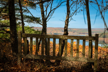 Park Bench in fall overlooking lake