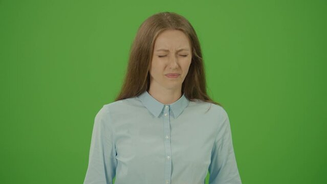 Green Screen. Chroma Key. Sick Young Female is Standing and Coughing and Holding her Inflamed Throat. Unwell Beautiful Woman Coughs and Having Pain in Throat. Infection and Virus. Health Concept