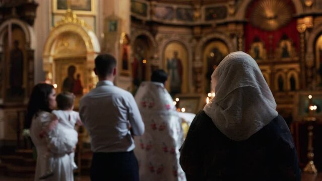 Defocused: Christening or baptising of a toddler in an orthodox church