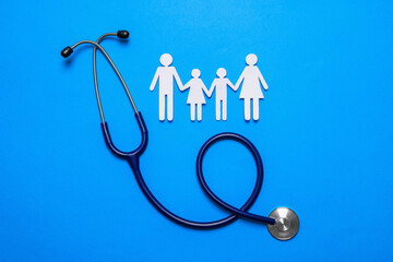 Paper family cutout and stethoscope on light blue background, flat lay. Insurance concept