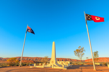 Anzac Hill War Memorial with its flags flying, is most visited landmark in Alice Springs, Northern Territory, Central Australia. The lookout offers a panoramic view of the town and surrounding ranges.