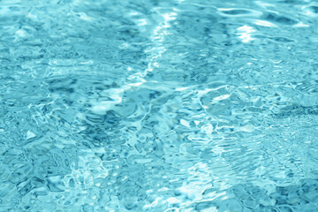 Rippled water in swimming pool as background