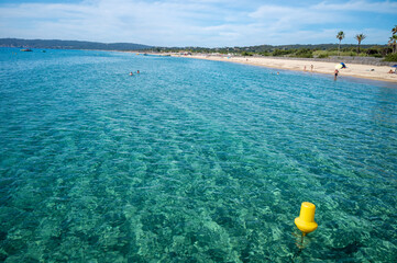 Fototapeta na wymiar Crystal clear blue water of legendary Pampelonne beach near Saint-Tropez, summer vacation on white sandy beaches of French Riviera, France