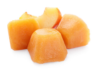 Frozen nectarine puree cubes and fruit on white background