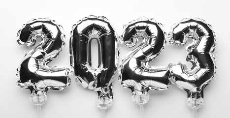 Figure 2023 made of silver balloons on white background
