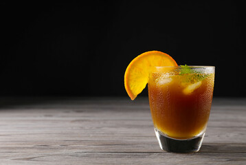 Tasty refreshing drink with coffee and orange juice on wooden table, space for text