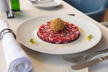Tartare beef served on a white plate in the restaurant