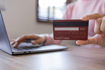 Asian woman hand using credit card and smartphone and  laptop for buying online shopping payments