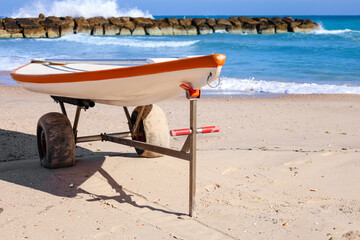 Modern boat on sand near sea