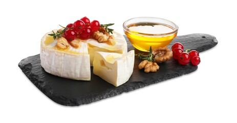 Brie cheese served with red currants, walnuts and honey isolated on white