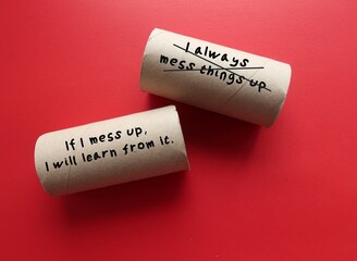 Toilet paper roll on red background with text written negative self talk I ALWAYS MESS THINGS UP,...