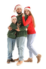 Happy parents with their little son in Santa hats on white background