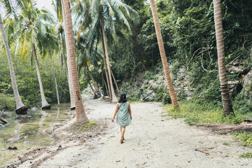 Fototapeta premium woman walk mangrove forest in Talet bay at Nakhon Si Thammarat province of Thailand.