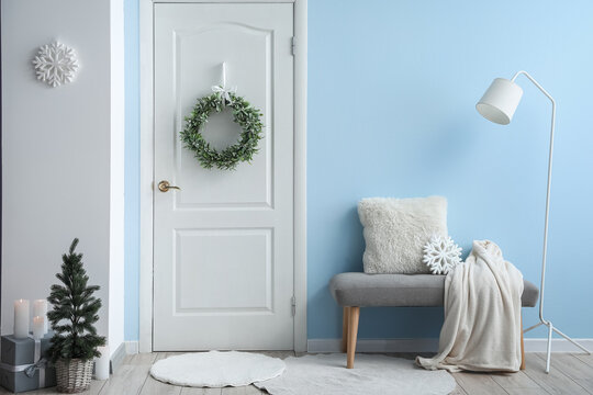 Stylish Christmas Mistletoe Wreath Hanging On Door In Room