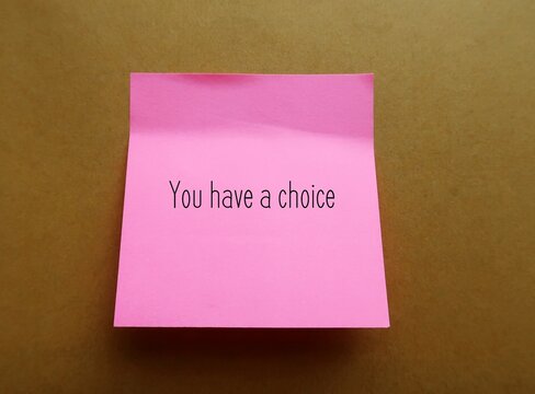 Pink note stick on office envelope with handwriting YOU HAVE A CHOICE, to remind self not to feel trapped, everyone have more choices available than realize in any given moment