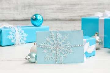 Letter to Santa with Christmas balls and presents on white wooden background