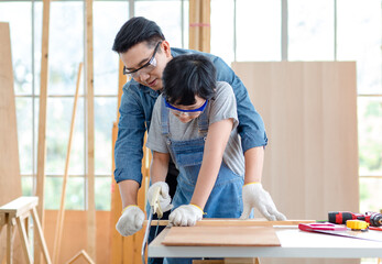 Asian professional male carpenter woodworker engineer dad in jeans outfit with safety gloves...