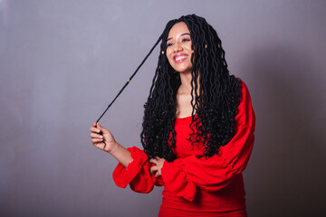 Beautiful black Brazilian woman, dressed in red. messing with the hair.