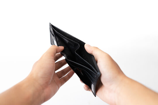 Hands hold black empty wallet with no money inside.