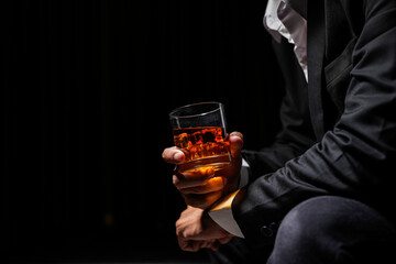 Closeup businessmen holding a glass of whiskey