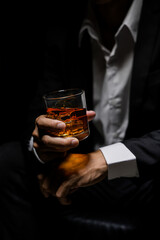 Closeup businessmen holding a glass of whiskey