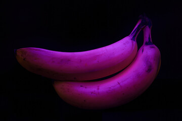 Glowing Pink Bananas on Isolated Black Background