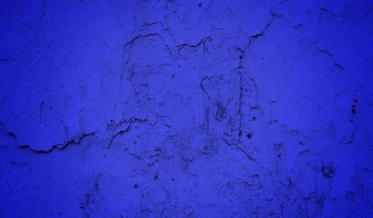 Old wall background in dark blue sided, Close up of cracked old cement texture. Peeling wall or road material