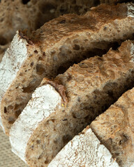 Sourdough bread with crispy crust on wooden shelf. Bakery goods