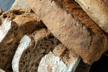 Sourdough bread with crispy crust on wooden shelf. Bakery goods