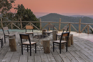 Fototapeta na wymiar Many chairs and fire place under sunset against mountain view in Da Lat Vietnam